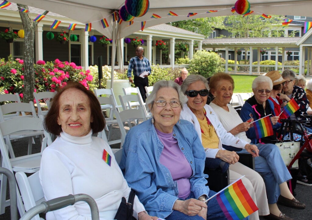 Goddard House residents smiling at outdoor event