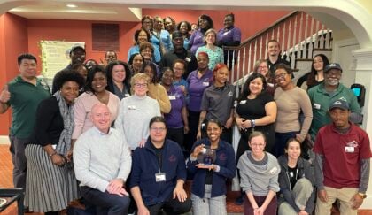 Group of associates posing with workplace award